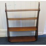 An early 19th century mahogany semi waterfall four tier wall shelf with shaped outline . 68cm wide
