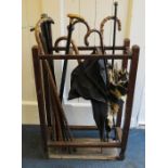 An Edwardian oak three section hall stick stand including coconut palm, malaca and Ceylonese ebony