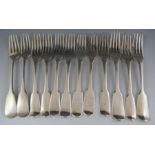 A matching but composite set of twelve, 19th century "fiddle pattern" silver desert forks, some