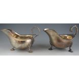 A pair of 18th century Irish style, silver sauce boats with leaf-capped scroll handles and "Dublin-