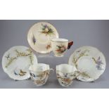 A Royal Worcester porcelain cup and saucer hand-painted with floral studies and a moulded handle