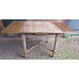 A 1920's stripped oak drawer leaf dining table with barley twist supports. 89cm square Provenance: