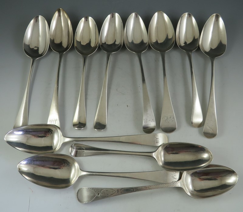 A composite set of mostly 19th century, English silver, soup spoons of various design, date and
