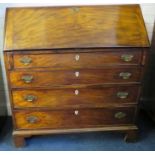 A George III mahogany full front writing bureau with simple fitted interior and four long drawers.