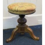 A Victorian figural rose wood revolving piano stool with tripod base Provenance: From The Sadia