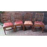 A set of four George III mahogany lathe back side chairs, 45cm wide, with rounded scroll backs and