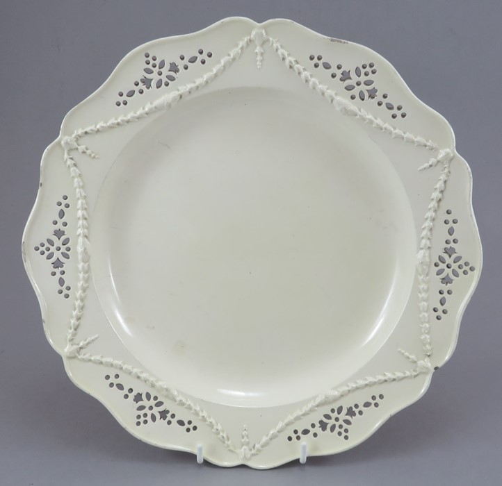 A late eighteenth century pierced creamware serving dish, c.1780. It has moulded classical swags and
