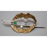 An emerald and diamond brooch, of open abstract form with a textured 9ct gold loop set with two