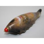 A Chinese agate snuff bottle carved as a sea cucumber with internal colouration and coral bead