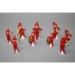 A 1920s Nine piece, German porcelain "Pixie-Band" cake decoration. Each bandsman dressed in red with