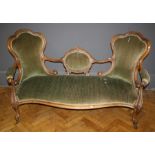 A Victorian walnut open frame twin camel back parlour settee with overstuffed seat on cabriole legs,