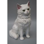 A 20th century Continental model of a seated white cat with pink nose and green / yellow eyes. 29