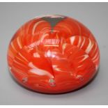 A Joe St. Clair paperweight with orange, white and bubble inclusions. 7cm diameter.