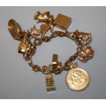 A 20th century 9ct yellow gold charm bracelet of thirteen mostly 9ct charms including, concorde,