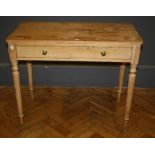 A Victorian stripped pine side table, the rectangular top over a frieze drawer with brass knop