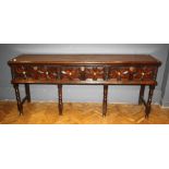 An 18th century and later oak low dresser, the rectangular planked top with moulded edge over