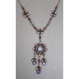 An opal and garnet(?) necklace having dominant floret pendant suspending three pendant drops on
