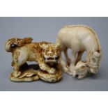 A Japanese Meiji period carved ivory netsuke in the form of a mare and her foal. 3.5cm long.