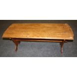 An elm coffee table with shaped end supports and pegged stretcher. 40 x 120 x 50 cms.