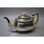 Probably William Bennett, a Geo III silver teapot with ivory fittings on four ball feet. London