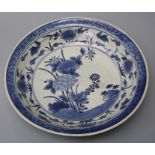 A Japanese, Meiji period, Arita blue and white porcelain circular charger/dish painted with a rock