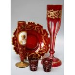An early 20th century cranberry and gilded glass vase decorated with a painted enamel plaque of a