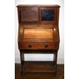 A circa 1900 oak student's desk in the manner of Liberty and Co. 129 x 69 cms.