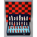 A set of simulated ivory chess pieces each carved as a long tailed parrot, with board in a fitted