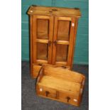 A 20th century imported Indian hanging cupboard with a pair of doors over two drawers together