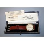 A 9ct gold Garrard gentleman's presentation wristwatch. Champagne Arabic dial with leather strap.