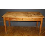 An early 20th century pine kitchen table, the rectangular top over two frieze drawers on square