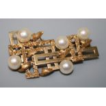 A gold and cultured pearl brooch of abstract design, polished panels and five cultured pearls.