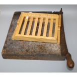 A vintage guillotine and a slatted wood cook book stand.