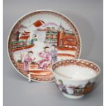 A Chinese, Qainlong, porcelain tea bowl and saucer painted with figures and buildings in the famille