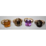 A single stone amethyst dress ring, a single stone citrine dress ring, a cats eye dress ring and a