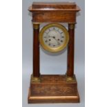 A Charles X, eight day, satinwood strung and marquetry inlaid rosewood portico clock with with