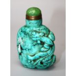 A Chinese turquoise coloured stone snuff bottle with jadeite stopper, decorated in relief with a