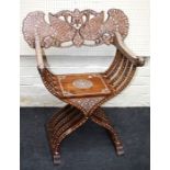 An ornate early 20th century Anglo-Indian rosewood, ivory inlaid, X frame folding chair. The pierced