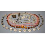 An amber bead necklace, a late Victorian locket, two bar brooches, a silver gilt necklace, three