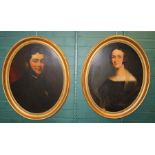 A pair of Victorian, oval three quarter length portraits of an unknown lady and gentleman in garb of