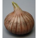 An oriental composition garlic bulb, realistically modelled and decorated with script. 7cms.