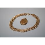 A 9ct rose gold float link bracelet and a gilt metal engraved oval locket (2)