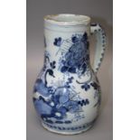 A late 18th century Dutch delft blue and white baluster loop handled jug decorated with peonies,