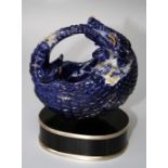 A 20th century lapis coloured stone desk piece carved as an armadillo on oval plinth with silvered