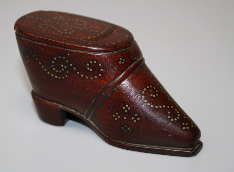 A 19th century treen snuff box fashioned as a short boot with gold coloured pique detail. 8 cms.