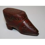 A 19th century treen snuff box fashioned as a short boot with gold coloured pique detail. 8 cms.