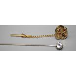 A tie pin fashioned as a gold nugget set with ruby coloured stones together with a paste set stock
