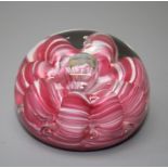A Joe St. Clair paperweight with pink, white and bubble inclusions. Stamped to base 7cms diameter.