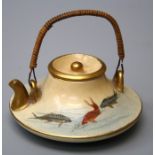A Japanese Satsuma small squat teapot with cane bound handle and swimming fish decoration. Seal