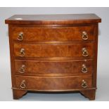 An early 20th century apprentice type miniature burr walnut veneer bow front chest of four graduated